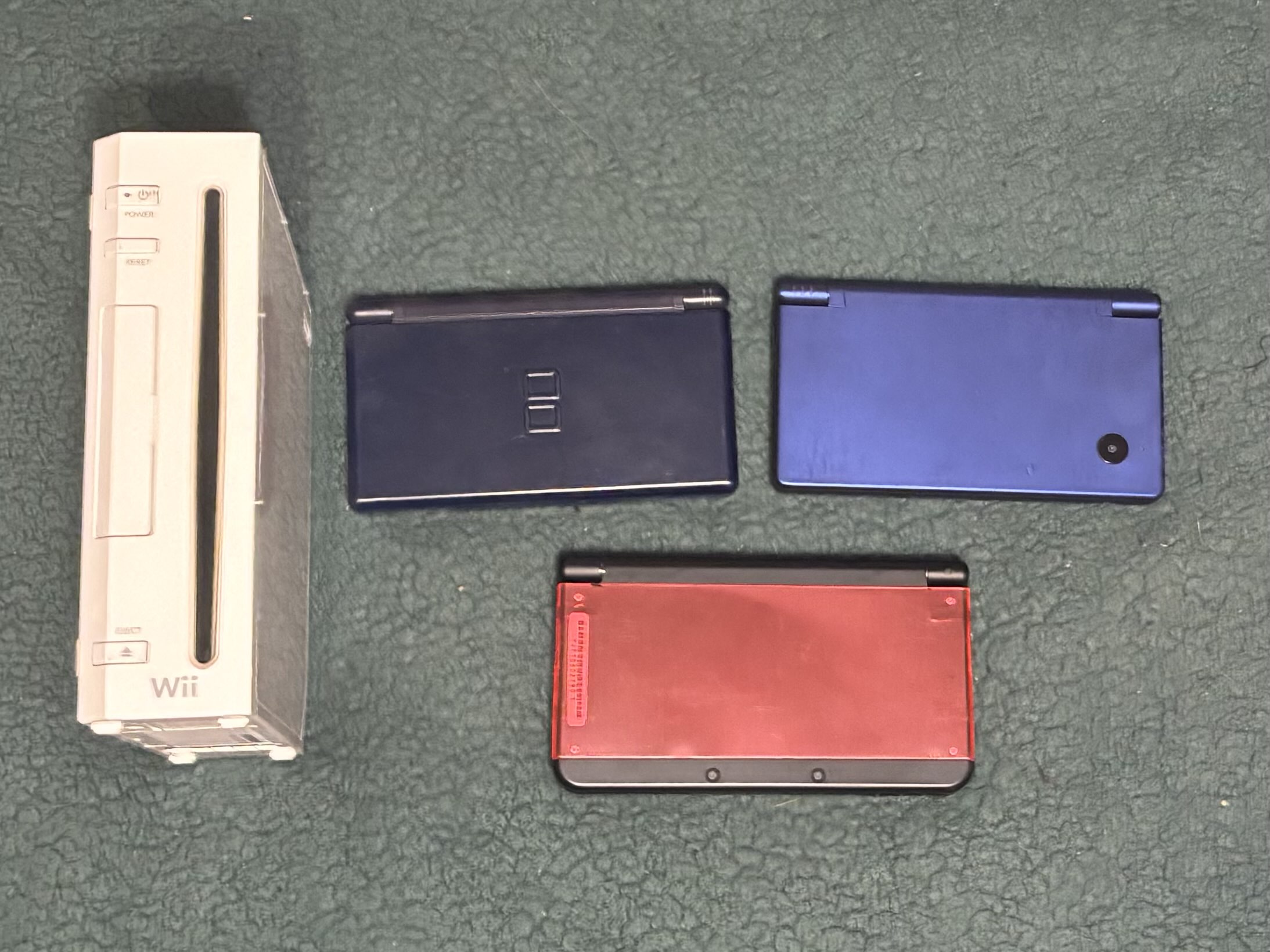 A picture of a Japanese Wii, DS Lite, DSi, and New 3DS